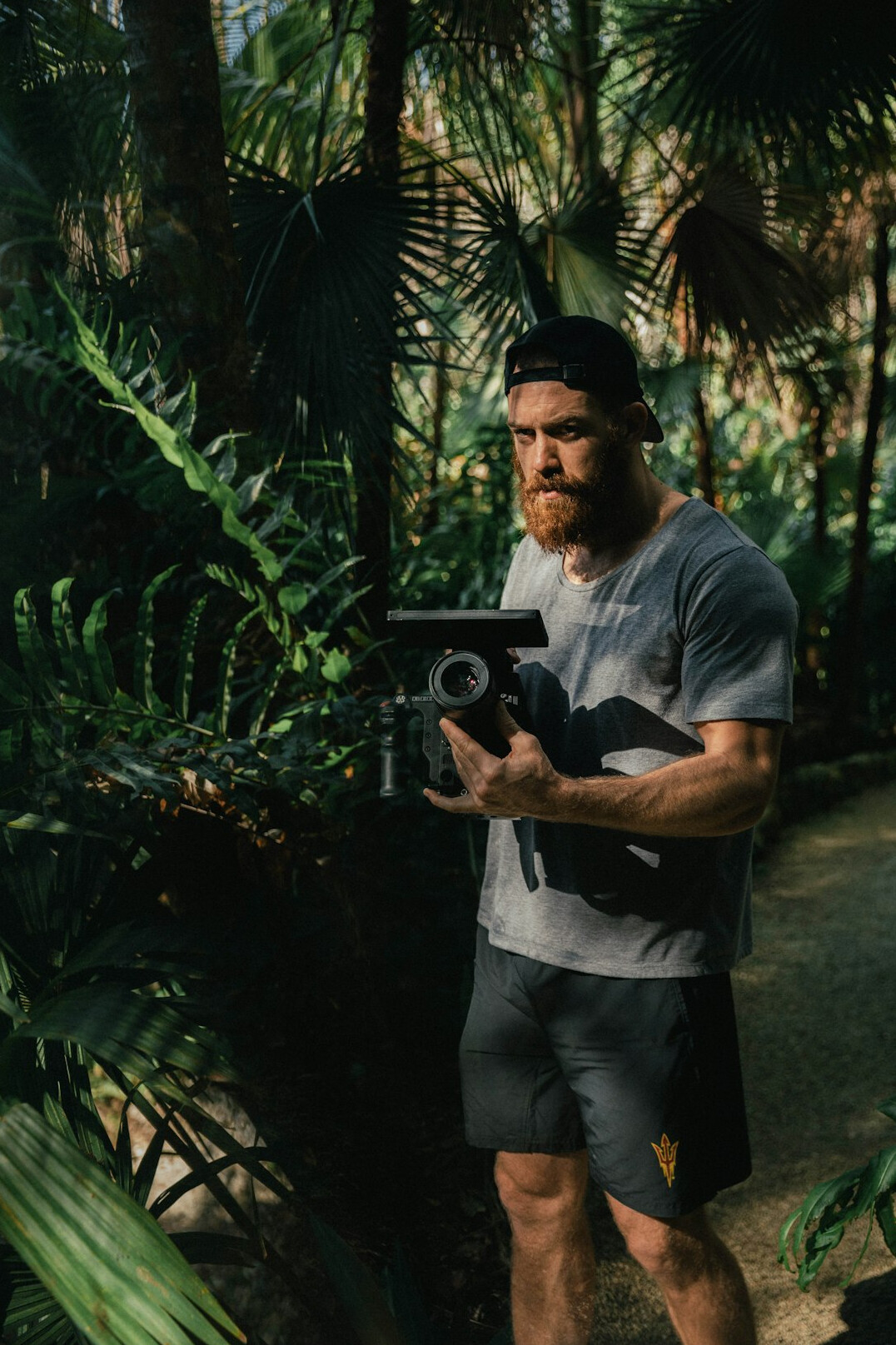 Portrait of a Turkish man cinematographer with a short beard holding a camera
